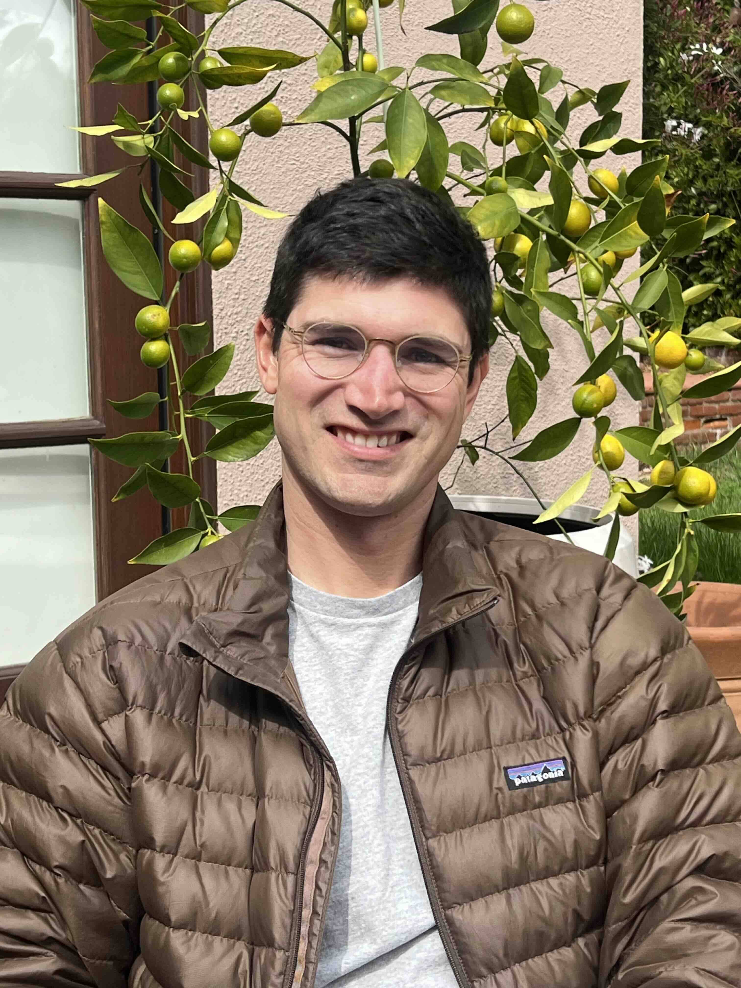 Hank Teicheira, wearing Patgonia jacket and glasses with Kumquat in background